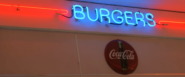 Neon burger sign with Coca Cola sign